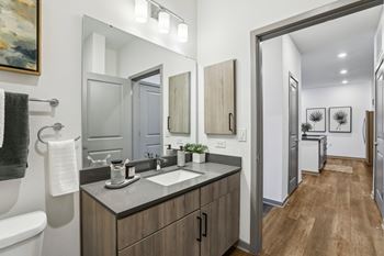 A bathroom with a white sink and a mirror above it.